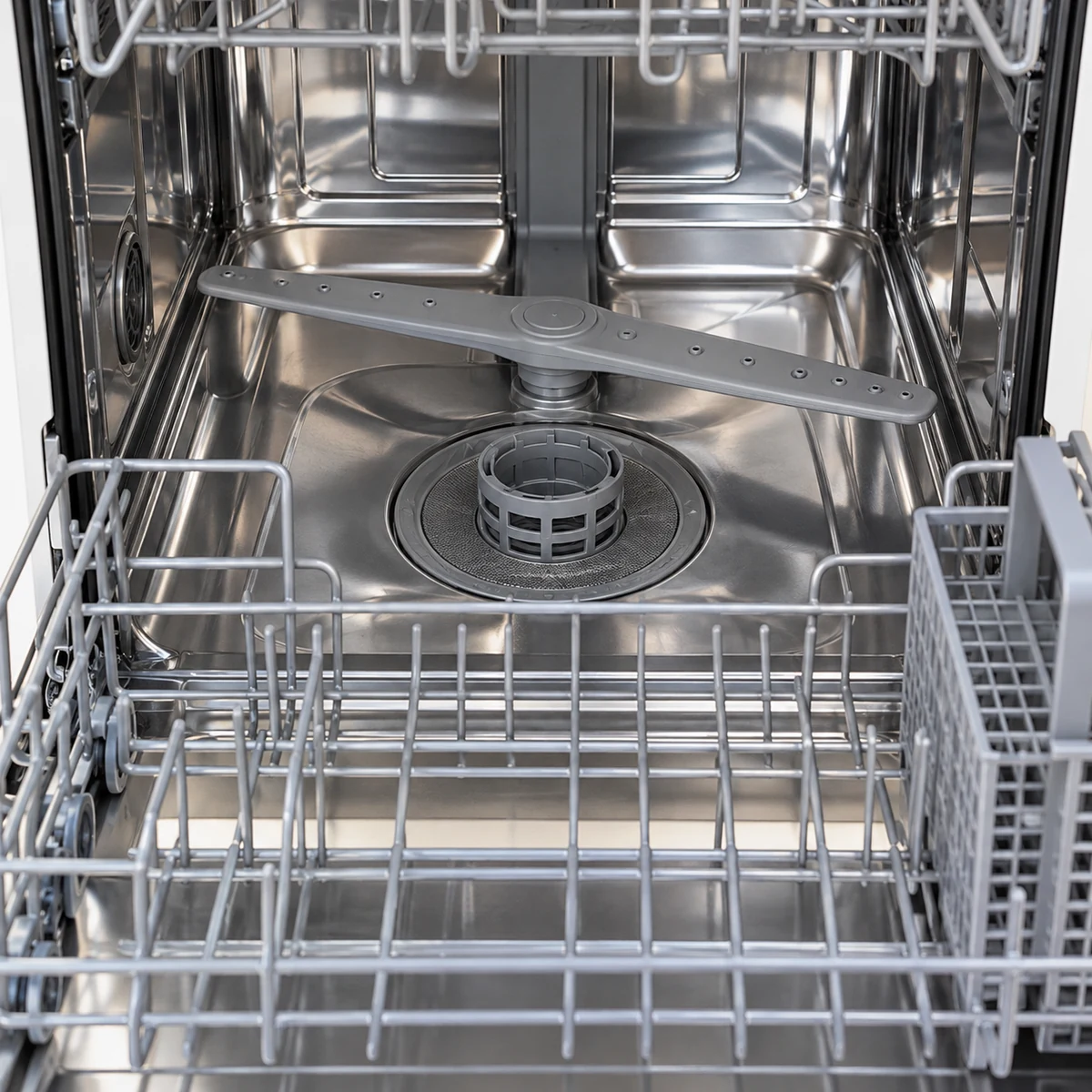 Lower rack pulled out to show a removable round filter at the bottom of a dishwasher